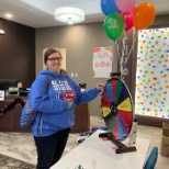 An assistant director spinning a prize wheel at an employee engagement event.