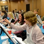 Summer Leadership Program students enjoy a canvas painting activity alongside staff.