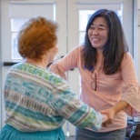 Life Enrichment Assistant dancing with a resident