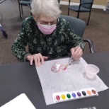 Resident of Oakleaf of Toledo celebrating Valentine's Day by making a heart sun catcher