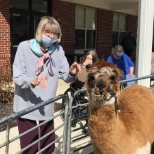 Residents of The Ashford at Sturbridge enjoying the day at a petting zoo